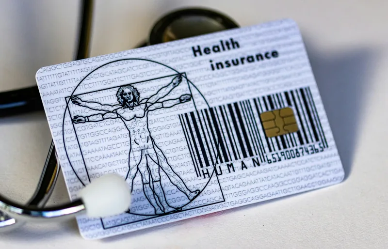 A health insurance card resting on a stethoscope