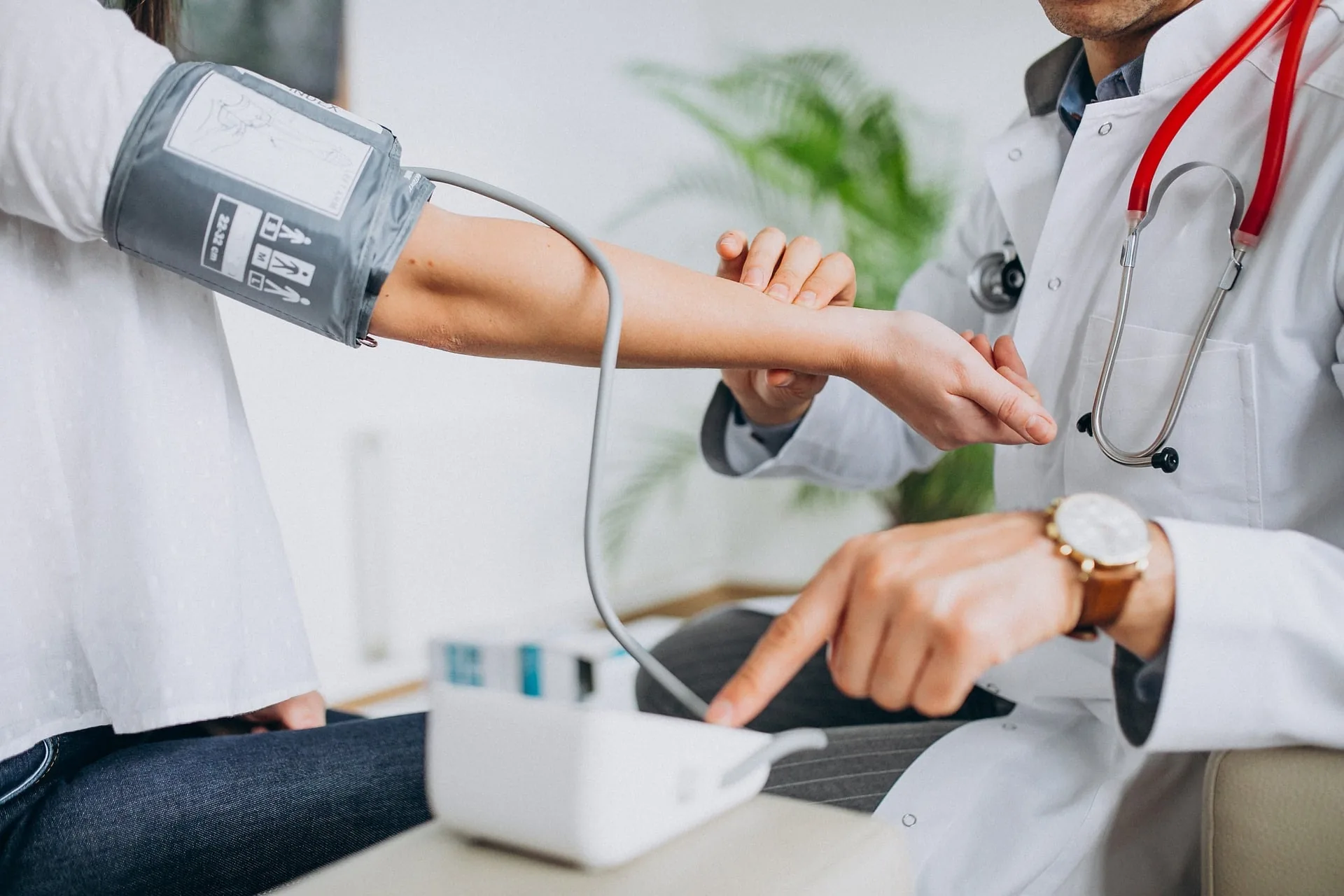 A clinician taking a blood pressure reading
