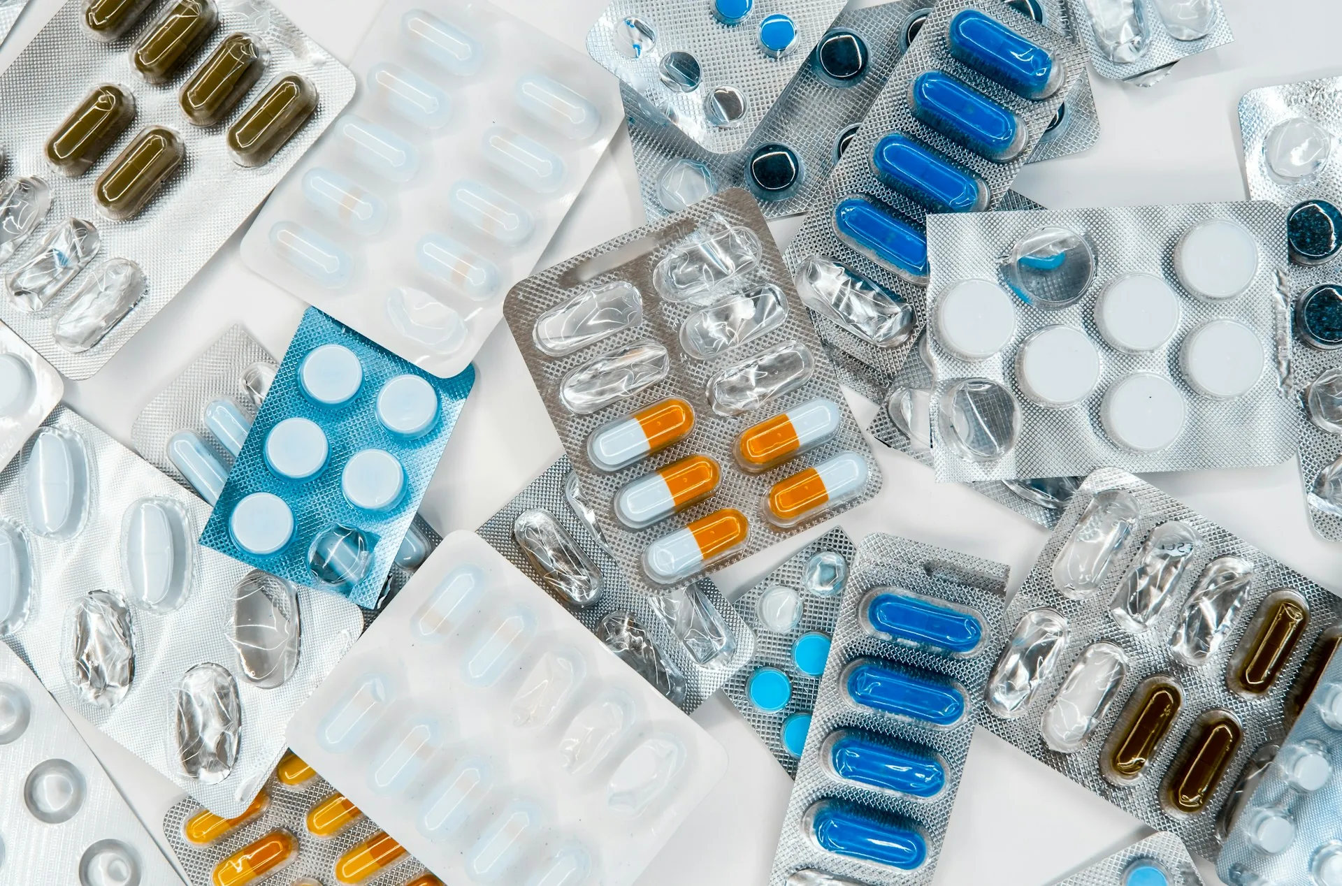Blister packs and boxed medicines on a dispensary counter
